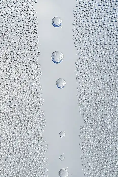 Close-up of water droplets scattered across a glass pane.