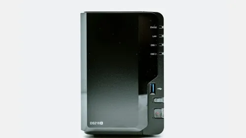 A black two-bay network-attached storage enclosure with status lights and front controls.
