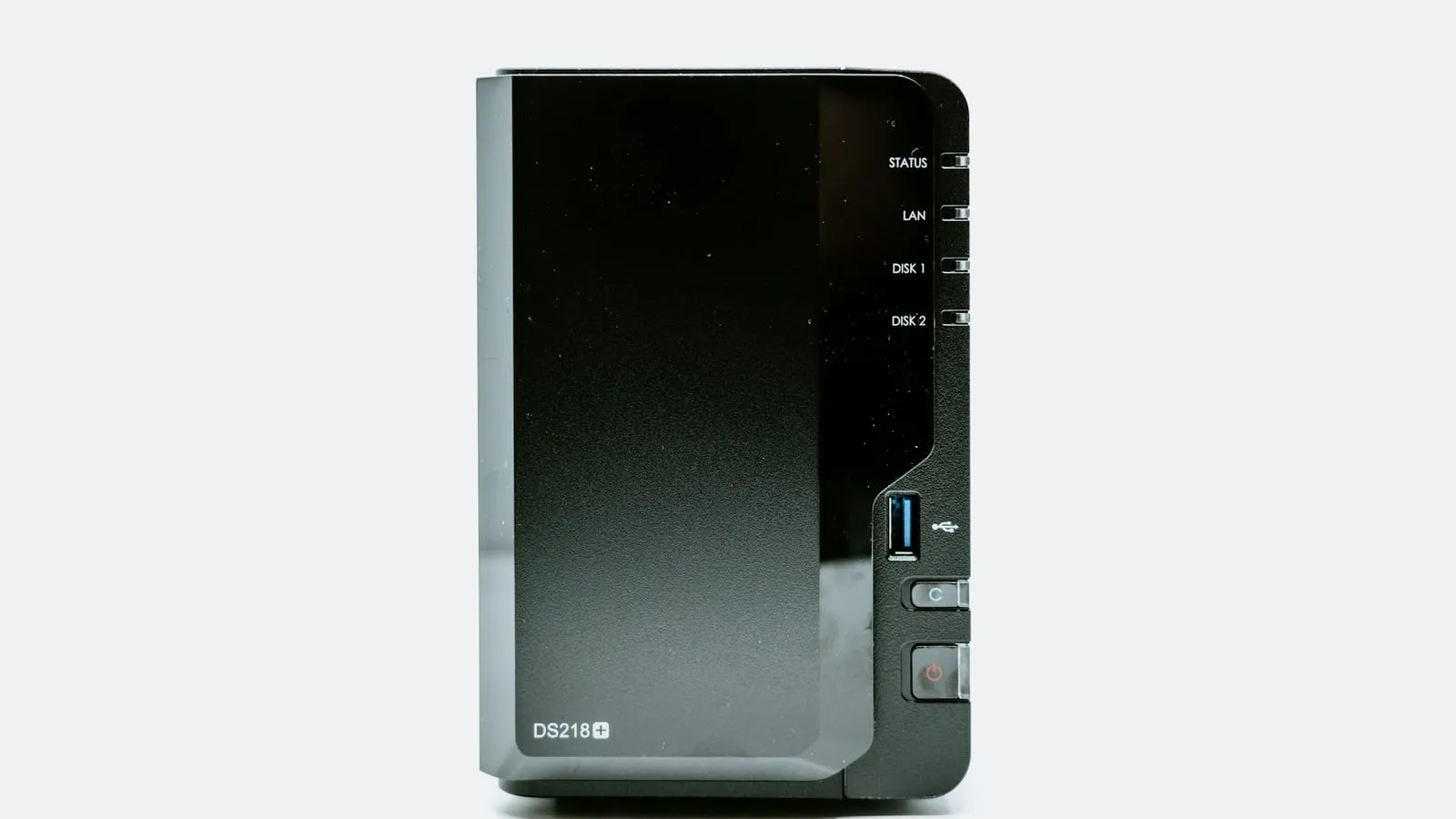 A black two-bay network-attached storage enclosure with status lights and front controls.