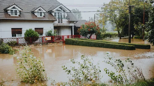 House and front yard surrounded by floodwater